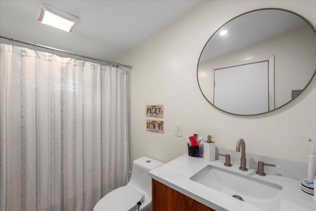 265 Hahana Road Haiku, HI 96708 - Photo 27 of 48 a bathroom with a sink mirror and a toilet