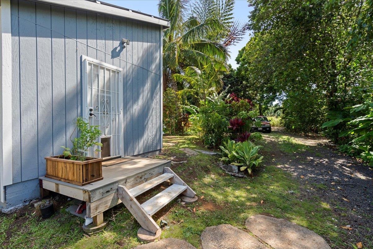 265 Hahana Road Haiku, HI 96708 - Photo 36 of 48 a wooden bench sitting in backside of a house