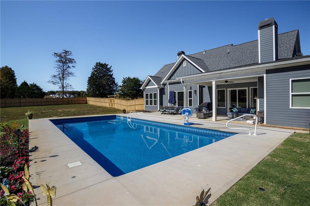 255 Old Town Road Dacula, GA 30019 - Photo 37 of 38 a view of a house with pool and chairs
