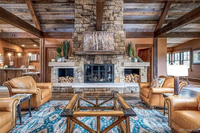 a living room with furniture a fireplace and a table