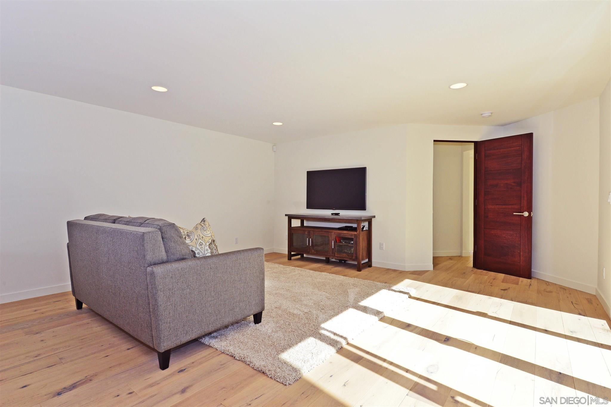 13721 Pine Needles Drive Del Mar, CA 92014 - Photo 16 of 32 a living room with furniture and a flat screen tv