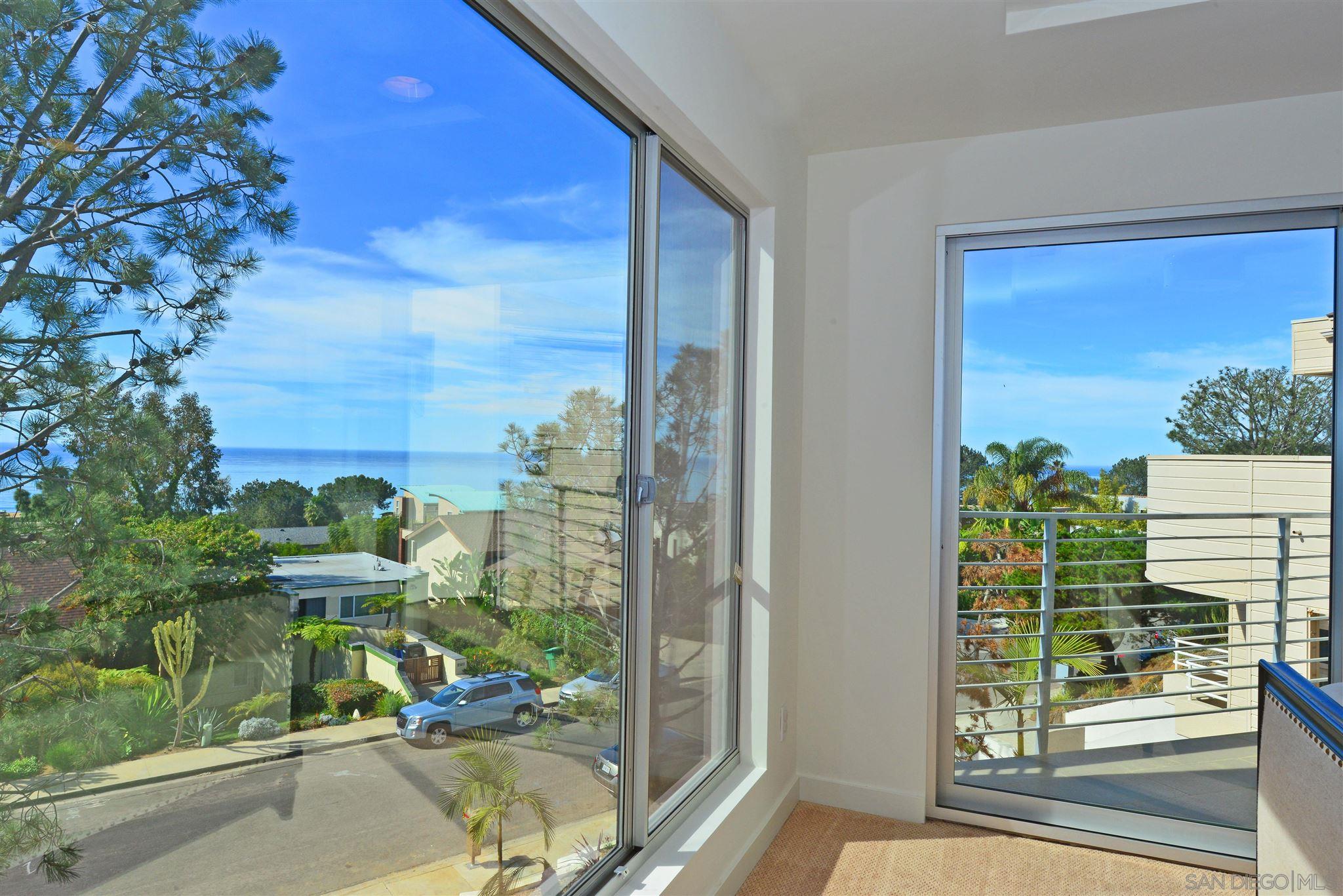 13721 Pine Needles Drive Del Mar, CA 92014 - Photo 2 of 32 a view of a porch with a floor to ceiling window and wooden fence