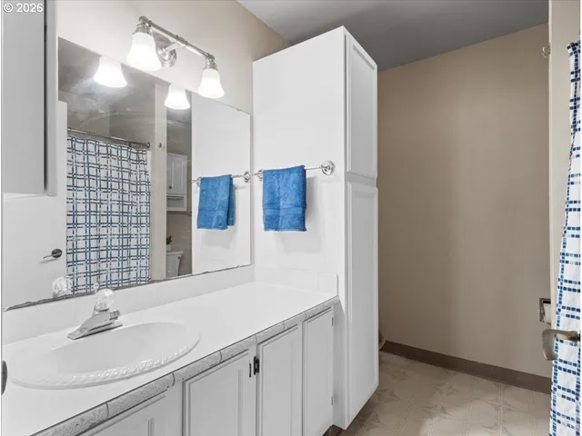 a spacious bathroom with a sink and a mirror