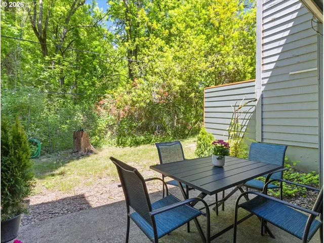 a view of a house with backyard and sitting area