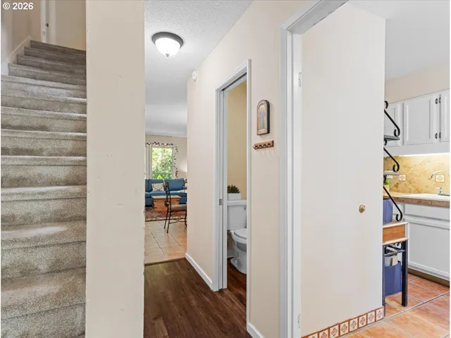 a view of a hallway view with wooden floor and staircase