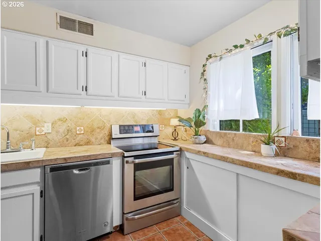 a kitchen with a sink stove and cabinets