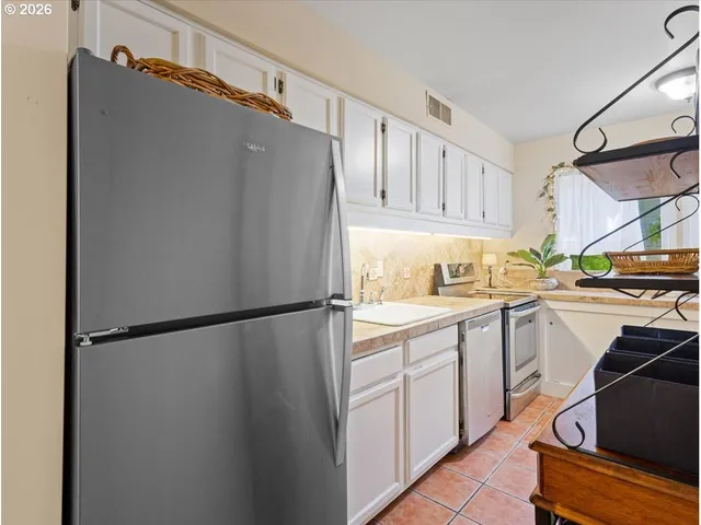 a view of a dining room with furniture a chandelier and wooden floor