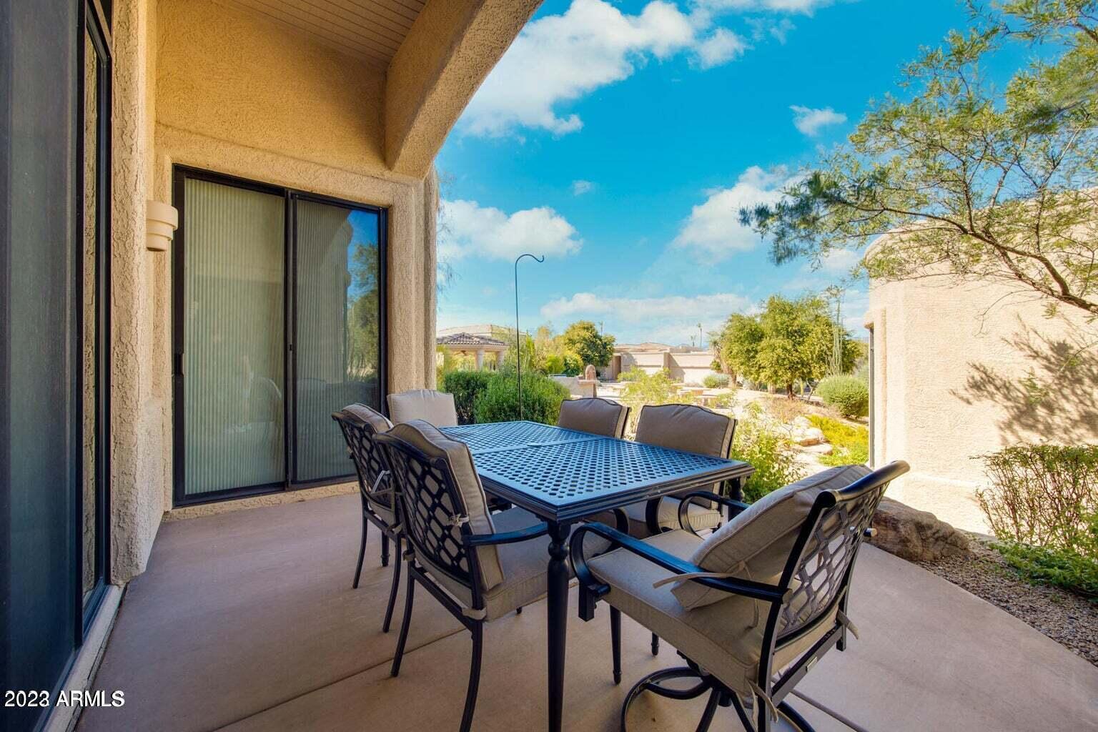 25603 North Sago Drive Rio Verde, AZ 85263 - Photo 15 of 25 a view of a patio with a table and chairs