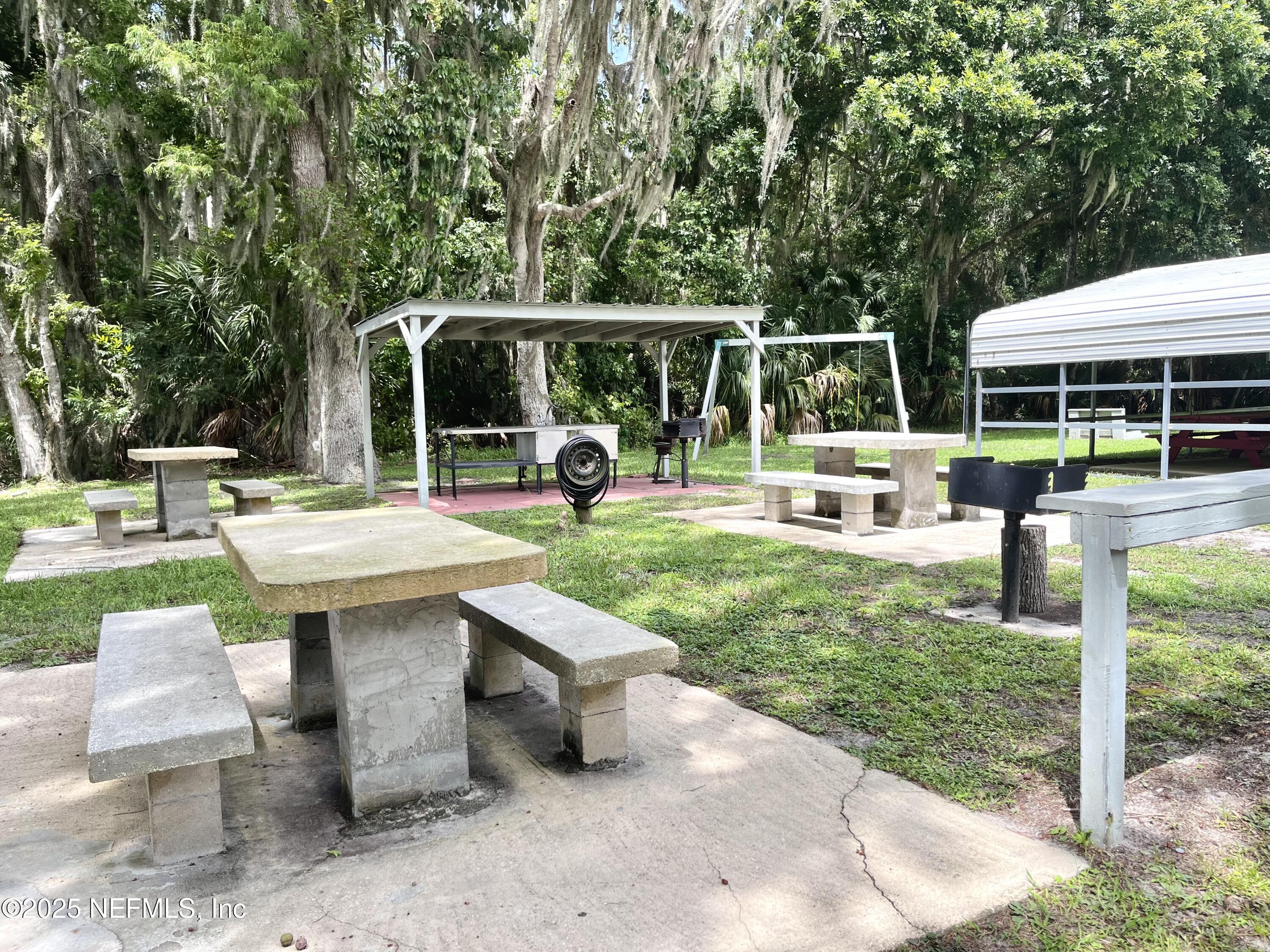 120 July Avenue Georgetown, FL 32139 - Photo 3 of 10 a view of a patio with a table chairs and a small yard