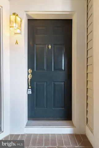 a living room with kitchen island a table and chairs in it