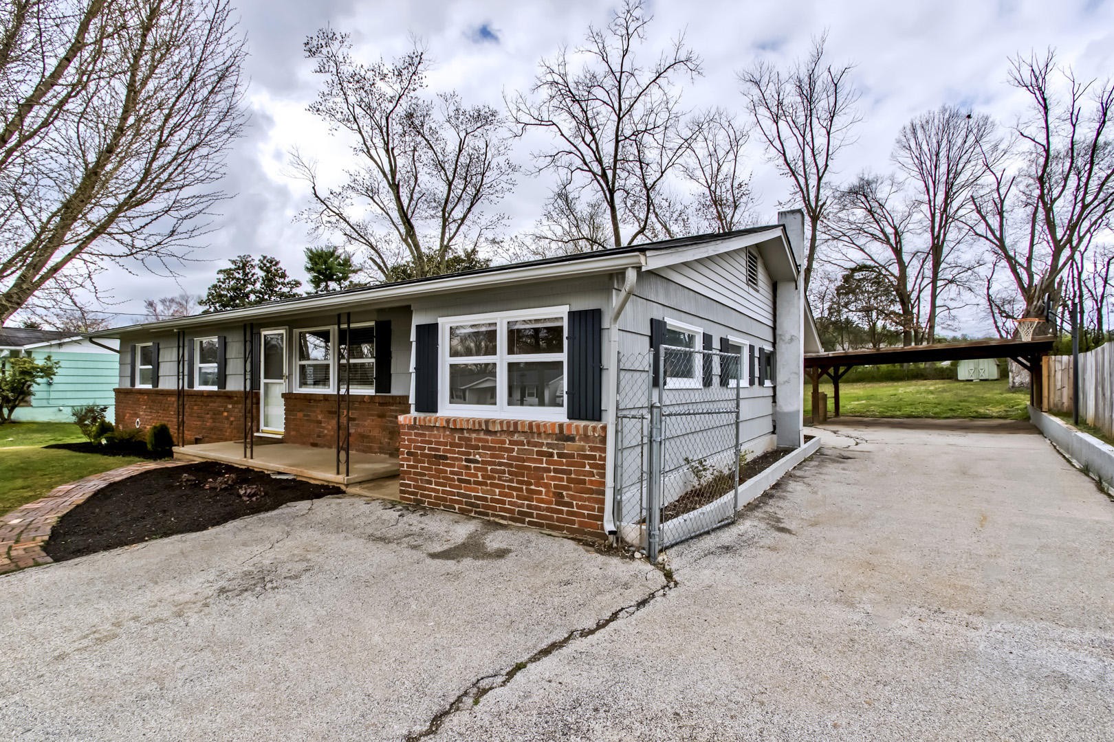 3109 Walnoaks Road Knoxville, TN 37921 - Photo 2 of 33 a front view of a house with a yard covered in snow