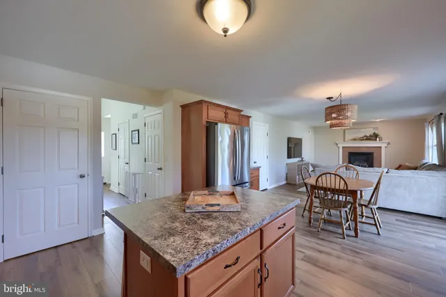 a dining room with furniture a window and wooden floor