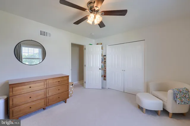 a bedroom with a large bed and a tv