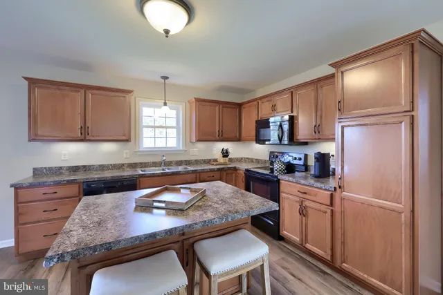 a kitchen with a refrigerator stove and microwave
