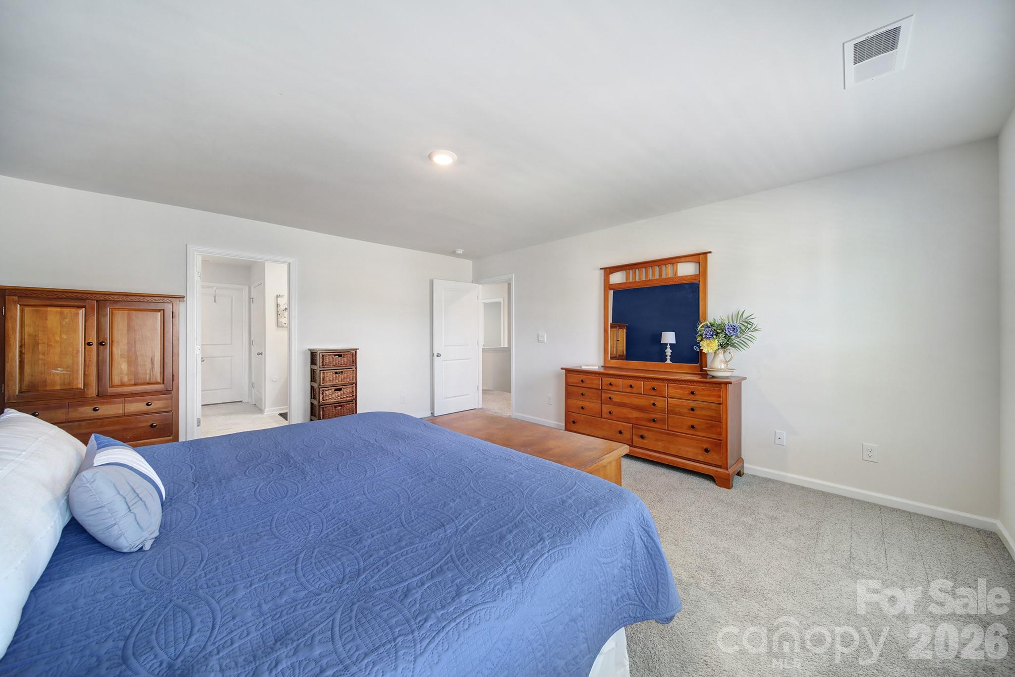 107 Spring Hall Court Troutman, NC 28166 - Photo 14 of 28 a bedroom with a bed and window
