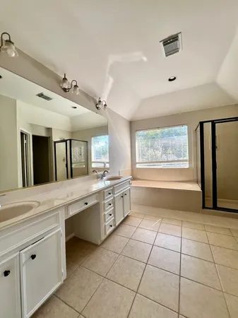 a large white kitchen with a large window