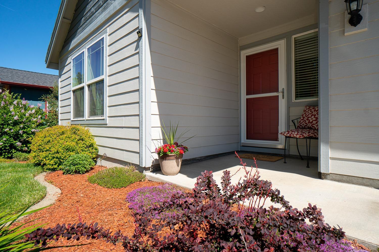 20564 Slalom Way Bend, OR 97702 - Photo 2 of 23 Nicely manicured front yard with a cover