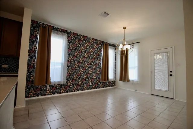 a view of kitchen with stainless steel appliances wooden floor and refrigerator
