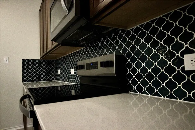 a view of a hallway with windows and chandelier