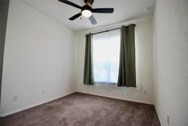 a bathroom with a bathtub a window and a shower