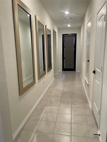a view of hallway with a glass door and door