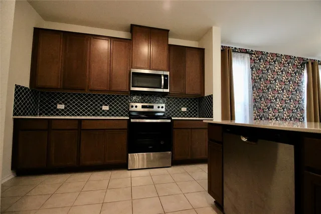 a kitchen with a sink and chandelier