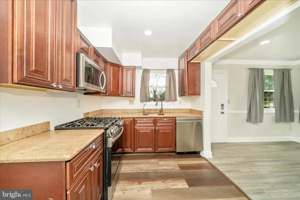 a kitchen with a sink stove top oven and cabinets