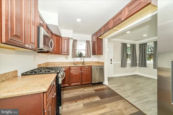 a kitchen with a sink a stove and cabinets