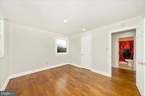 a view of a room with wooden floor and entryway