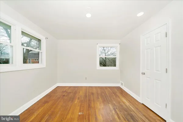 a view of a room with wooden floor and windows