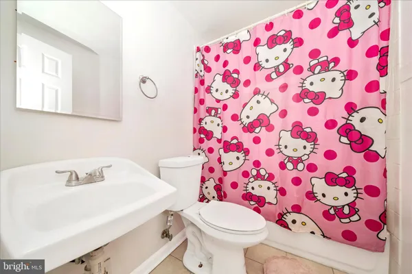 a white toilet sitting next to a bathroom sink