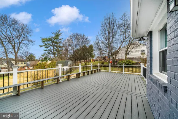 a view of house with deck and outdoor seating
