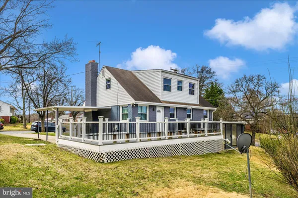 a view of a house with a wooden deck