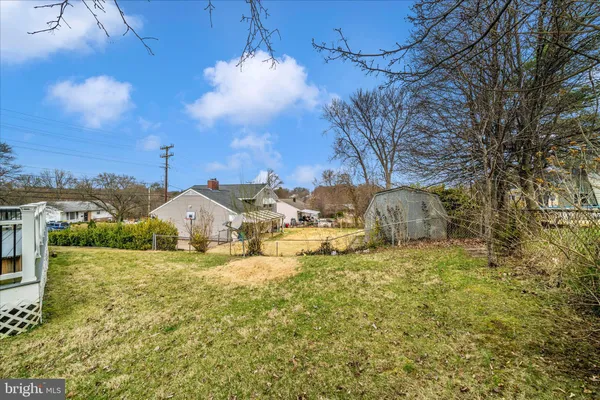 a backyard of a house with yard and outdoor seating