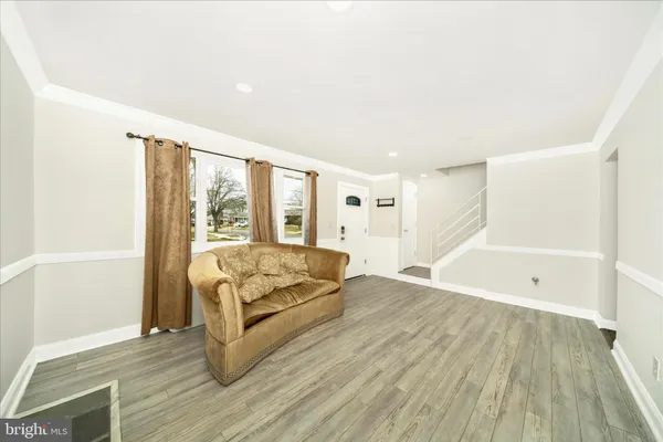 a spacious bedroom with a bed and a wooden floor