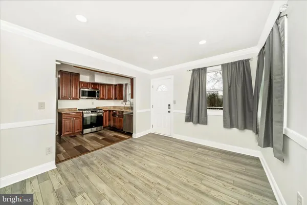 a view of a kitchen with a sink cabinets and wooden floor
