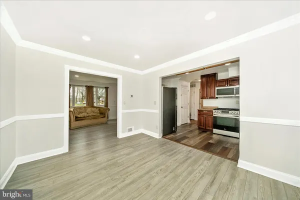 a bedroom with a bed and a view of kitchen
