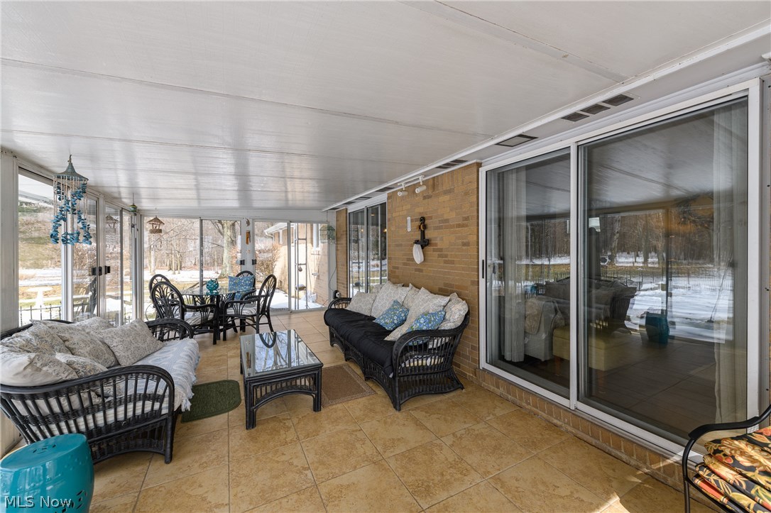 14719 Industry Road Atwater, OH 44201 - Photo 11 of 22 Sliders from the dining room and family room lead to the enclosed patio
