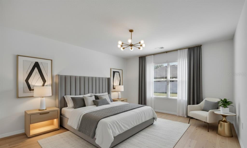 1828 Partin Terrace Road Kissimmee, FL 34744 - Photo 16 of 47 a spacious bedroom with a bed and a chandelier