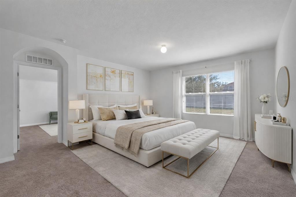 1828 Partin Terrace Road Kissimmee, FL 34744 - Photo 22 of 47 a spacious bedroom with a bed and a couch