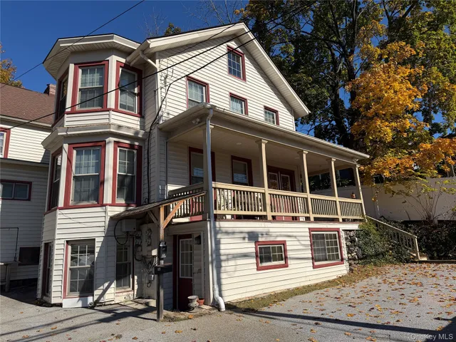 a view of a white house with large windows