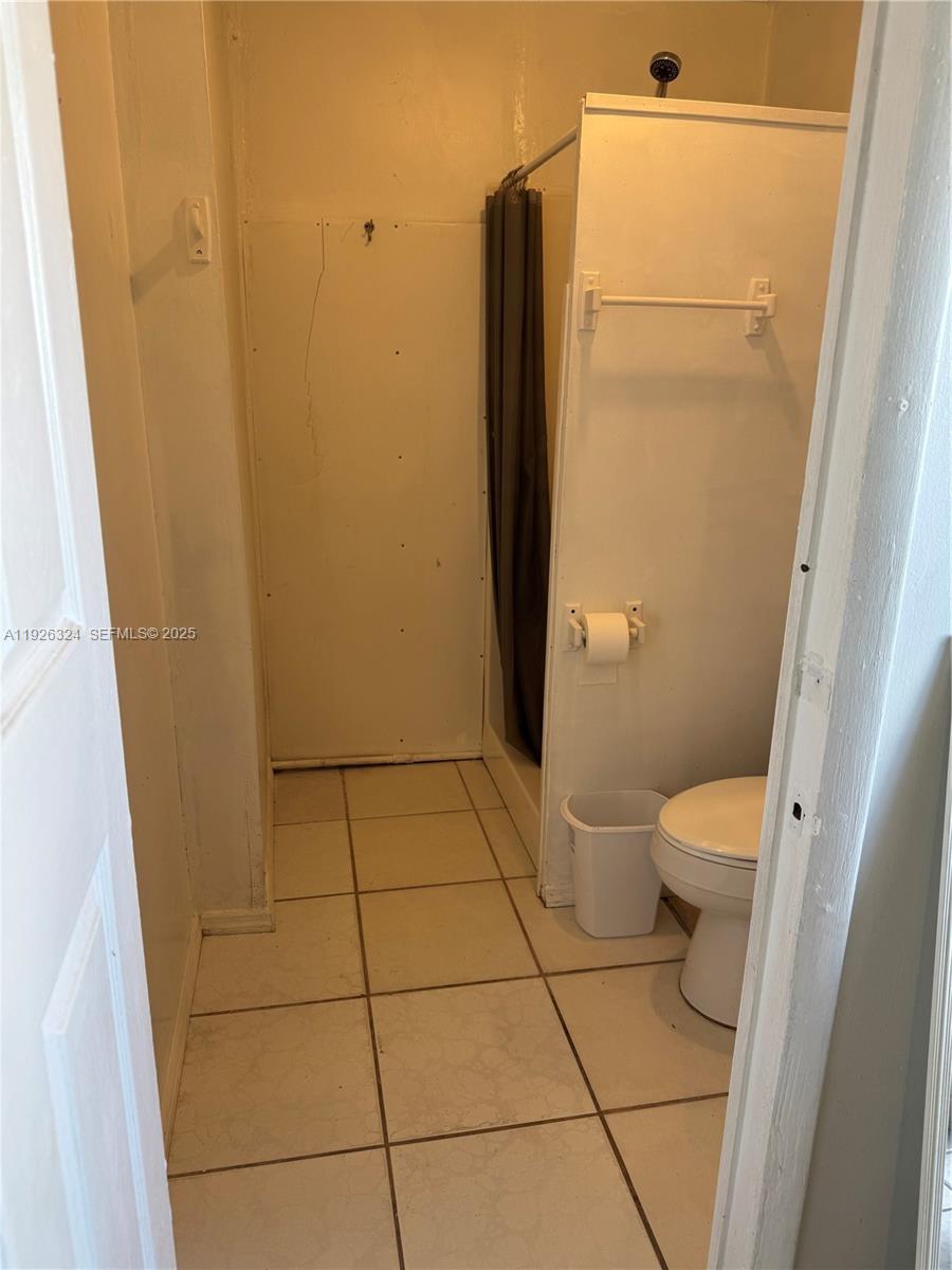 Boulevard Heights Pembroke Pines, FL 33024 - Photo 7 of 13 a bathroom with a granite countertop toilet and a shower