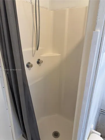 a bathroom with a glass door shower