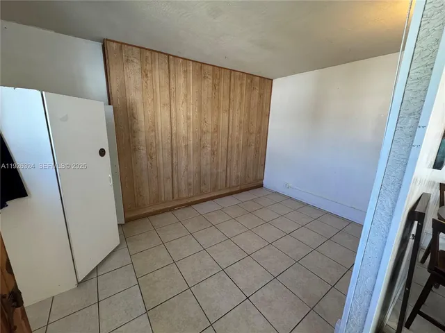 a view of a utility room with cabinets