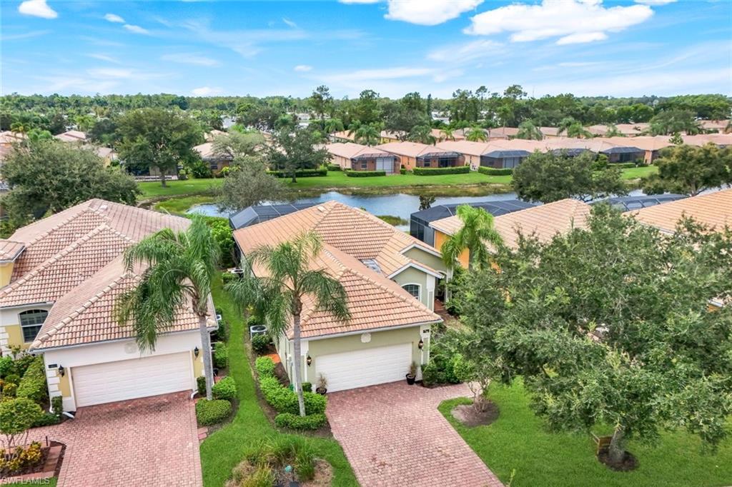 14846 Toscana Way Naples, FL 34120 - Photo 2 of 33 a view of a garden with an outdoor space