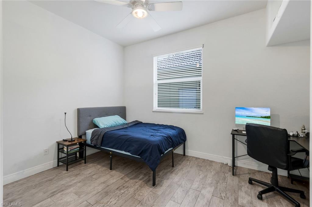 14846 Toscana Way Naples, FL 34120 - Photo 21 of 33 a bedroom with a workspace and a window