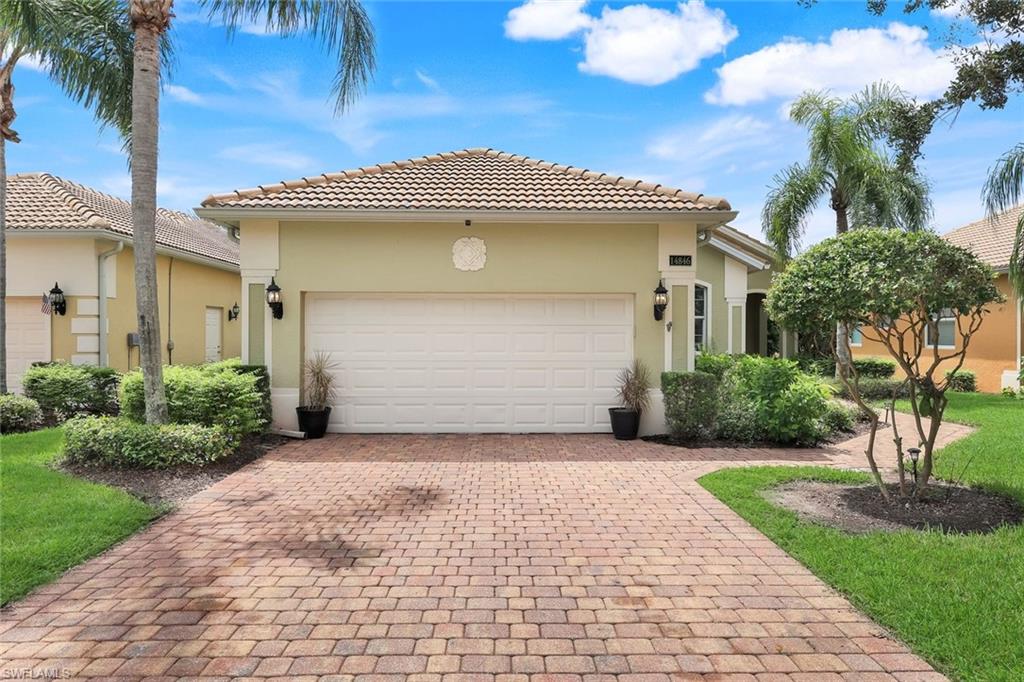 14846 Toscana Way Naples, FL 34120 - Photo 27 of 33 a front view of a house with a garden