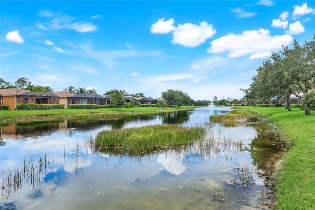 14846 Toscana Way Naples, FL 34120 - Photo 28 of 33 a view of a lake with houses in the back