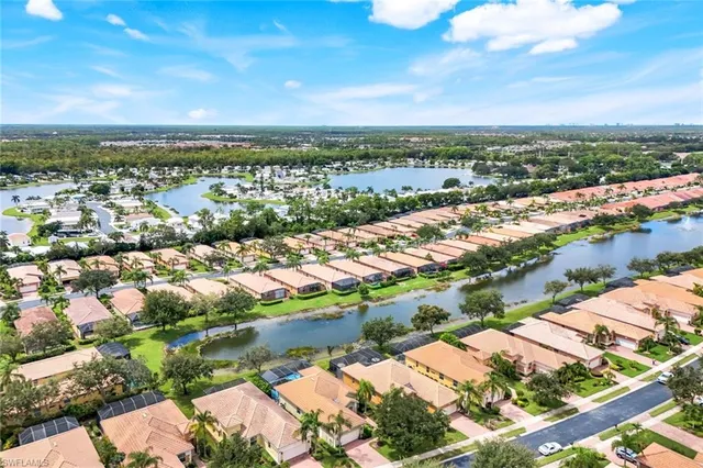 a view of a lake with houses in the back