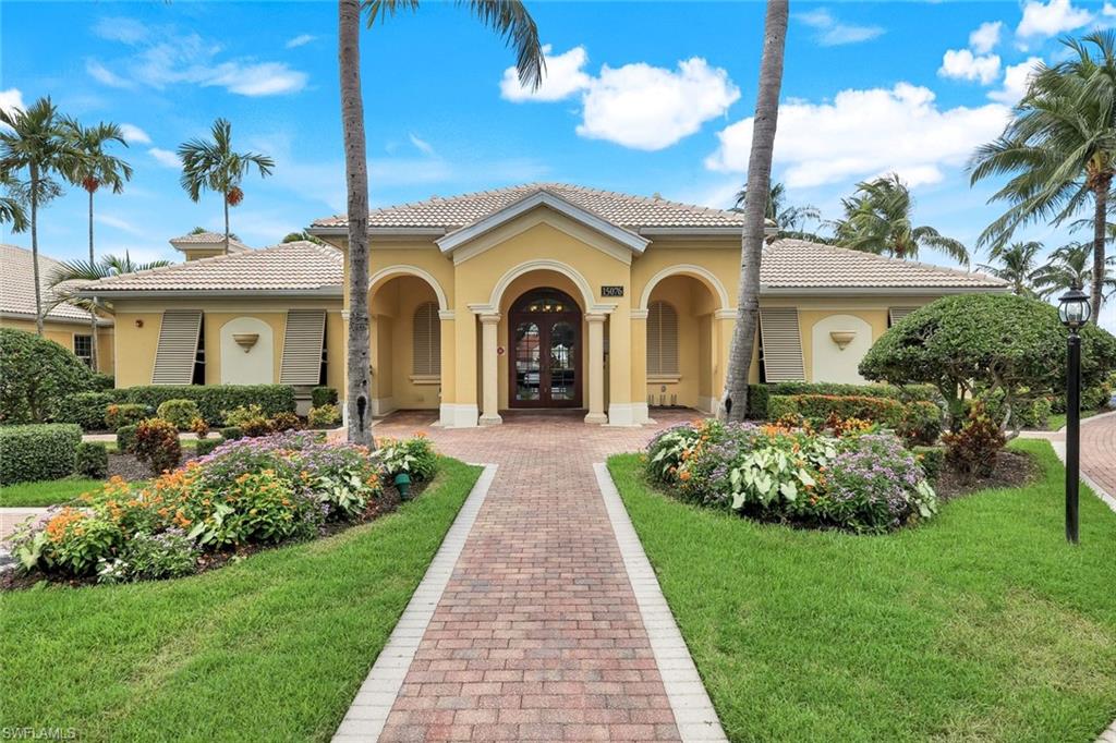 14846 Toscana Way Naples, FL 34120 - Photo 32 of 33 a front view of a house with a garden